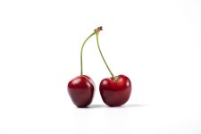 Red and black cherries on white background. High quality photo